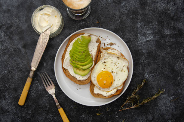 istock Avocado and fried egg toast for breakfast. Healthy food. Top view. 1280878895