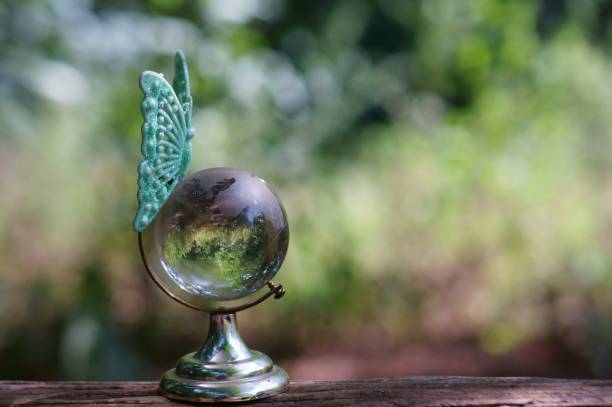 istock A toy butterfly on a small glass globe. 1280881086