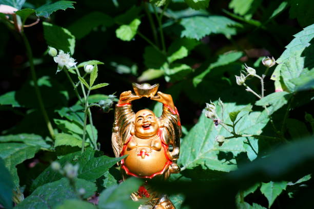 istock Buddha figure on a background of green grass. 1280881138
