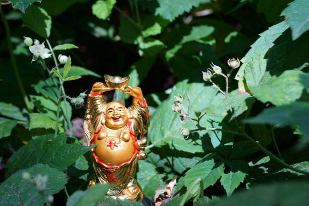 istock Buddha figure on a background of green grass. 1280881178