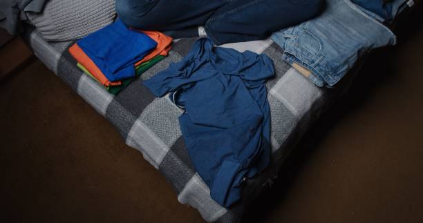 складная и сортированная одежда дома - polo shirt multi colored clothing variation стоковые фото и изображения