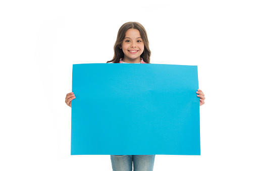 Happy child with blue promo board isolated on white. place for ad or announcement. Girl with smile hold empty poster for sale. Smiling beauty. Cute and adorable. Advertising your product, copy space.