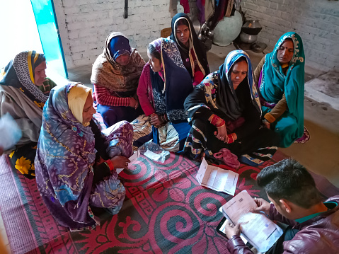 DISTRICT KATNI, INDIA - JANUARY 16, 2020: Indian village women grouping for Micro finance loan repayment, small group meeting program.