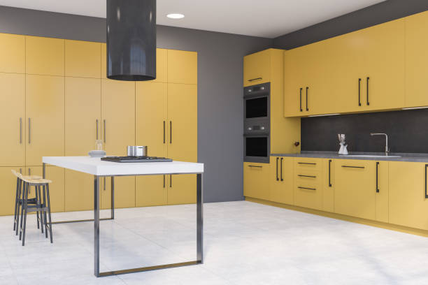 istock Gray and yellow kitchen with bar and cabinets 1280886281