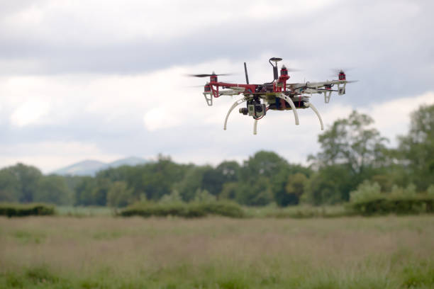 istock Hex copter camera drone hovers in front of a rural background. 1280886454