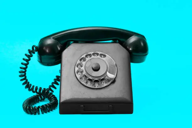 Photo of A vintage dial phone from the 80s in abstract vivid colors.  Retro style landline telephone art.
