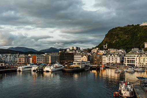 Ålesund old town port at fall evening with various boats by the pier, Norway