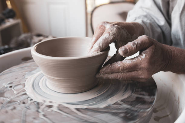 istock Woman's Hands Shaping Clay into Bowl on Pottery Wheel 1280892212