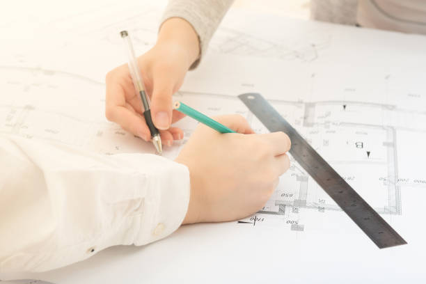 istock Collaboration, teamwork. A group of engineers discuss architectural drawings at a meeting in the office 1280892335