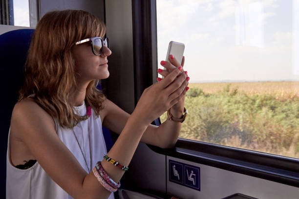 istock Woman riding in a train / metro wagon and using cellphone. 1280893405