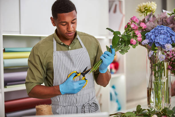 istock Handsome man working as florist in shop 1280894980