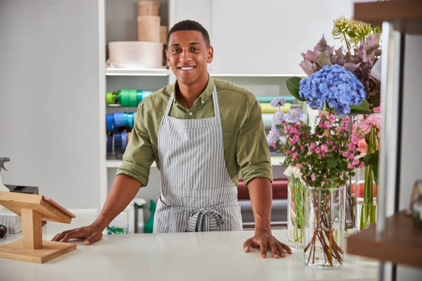 istock Happy young man enjoying working day at florist 1280895020