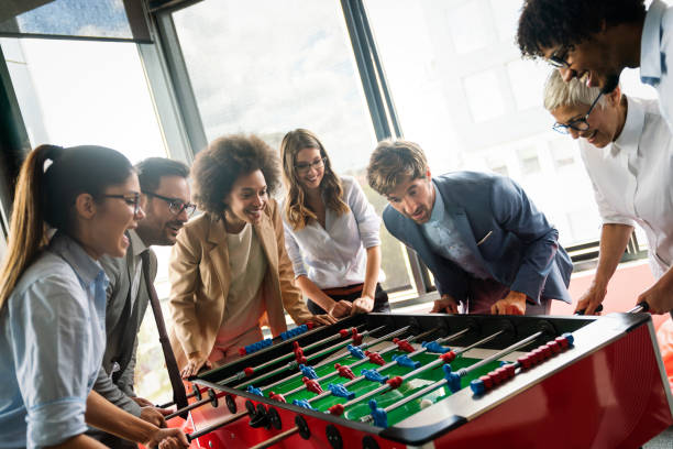 istock Colleagues playing table football in the break. 1280899114