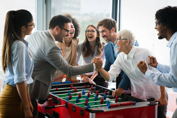 istock Coworkers playing table football on break from work 1280899131
