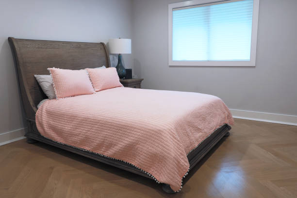 Bedroom in luxury home with pink comforter
