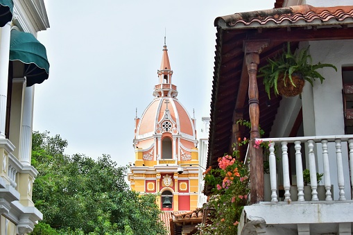 Colorful dome of a church in Cartagena between beautiful balconies