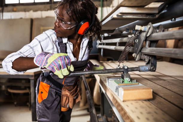 istock One African-American female carpenter working with wood in her workshop. 1280901601