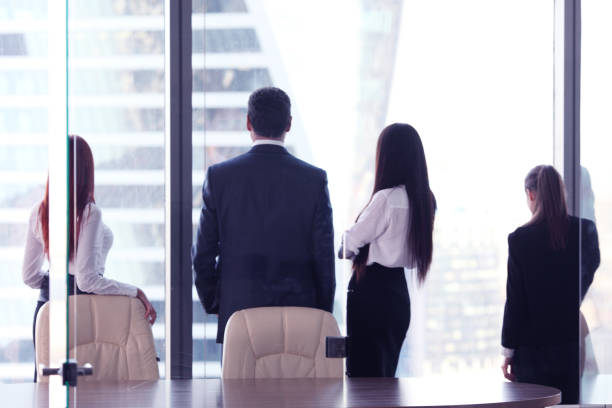 istock Business people looking at window 1280906531