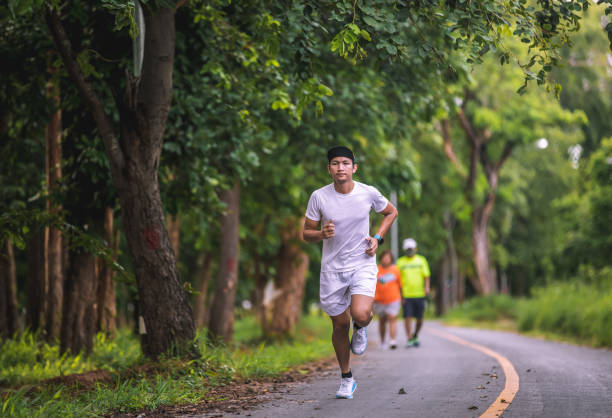 istock Asian men jogging and running in the park 1280908745