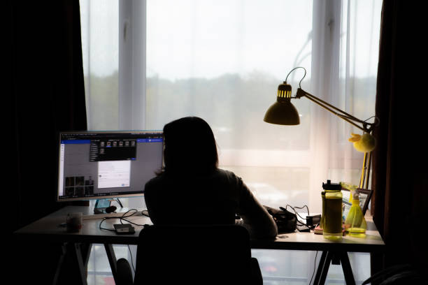 istock woman working on PC at home silhouette 1280909779
