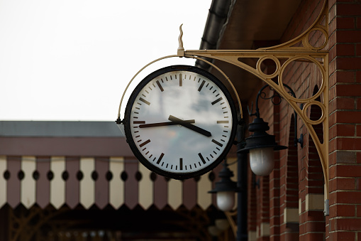 Old fashion retro clock in steam train station.