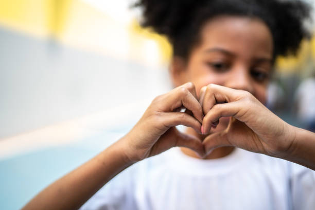 istock Schoolgirl uisng hands forming a cute heartshape 1280911859