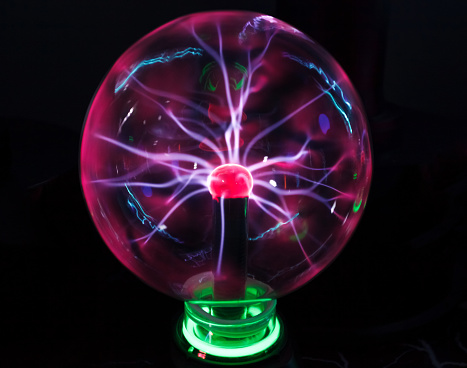 Glass ball with plasma Tesla lightning bolts.