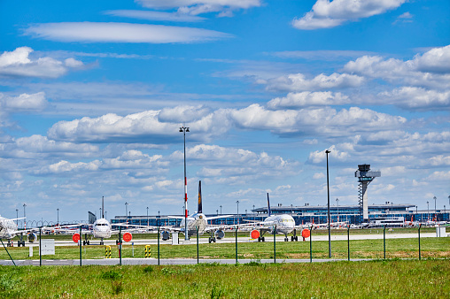 Berlin-Schoenefeld, Germany - May 20, 2020: Airplanes parked at Berlin-Schoenefeld Airport that are not needed due to the corona pandemic.