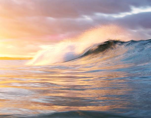 istock Motion blur - An oncoming golden wave breaks in bright colours - Australia 1280917646