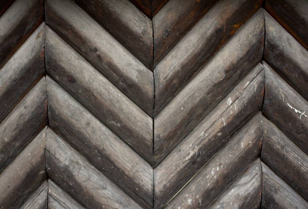 istock Close view of Chevron pattern wooden logs. Chevron Pattern Log Fence Panel. 1280925407