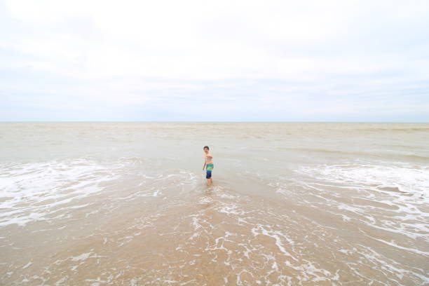 boy playing in sea water