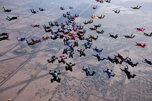 April 27, 2012. Eloy, Arizona, United States. A large group of skydivers jump from various aircraft.