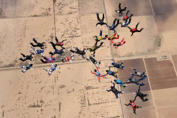 April 23, 2012. Eloy, Arizona, United States. A large group of skydivers jump from various aircraft.