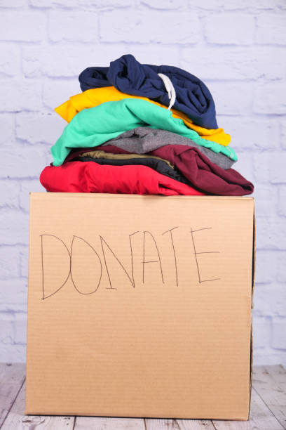istock Donation box with donation clothes on a wooden table . 1280927920