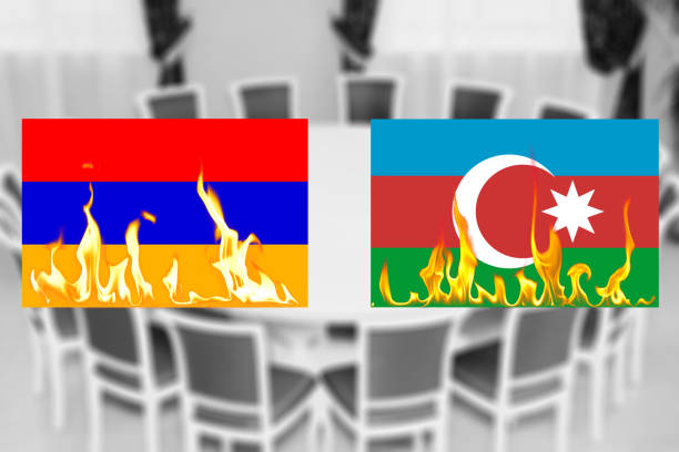 Flags of Azerbaijan and Armenia on fire on the background of the round table. The truce of the warring parties Flags of Azerbaijan and Armenia on fire on the background of the round table. The truce of the warring parties or diplomatic negotiations on the cessation of hostilities truce flag stock pictures, royalty-free photos & images