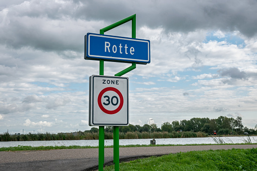 Place name sign of Rotte, a scenic area along river Rotte close to Rotterdam, Holland. Sign below means that maximum speed is 30 kilometers per hour.