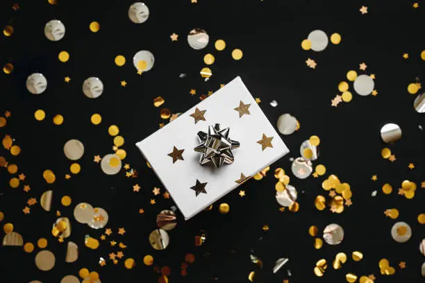 Photo of Box with a gift and confetti