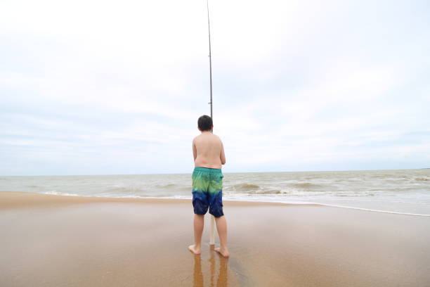 child fishing on the beach