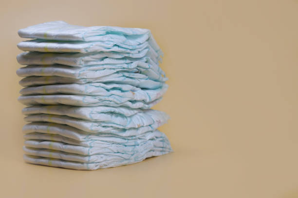 istock stack of diapers on a light background, baby hygiene products 1280933843