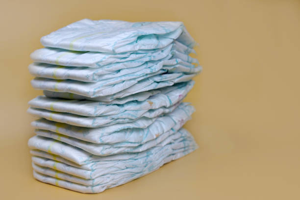 istock stack of diapers on a light background, baby hygiene products 1280933852