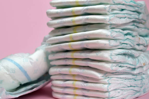 istock stack of diapers on a pink background, baby hygiene products 1280933891