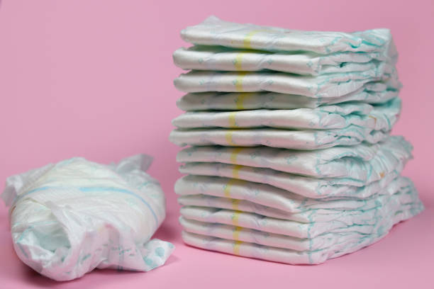 istock stack of diapers on a pink background, baby hygiene products 1280933905