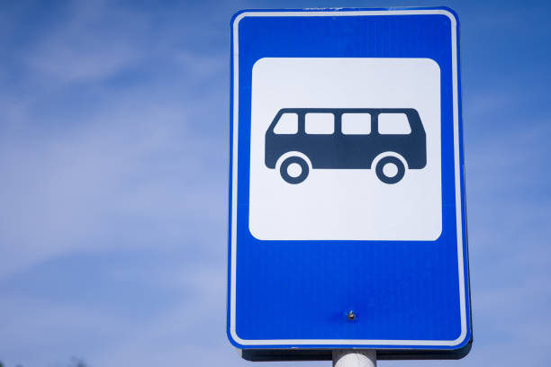 istock Blue and white bus stop sign in Europe with sky background 1280935484