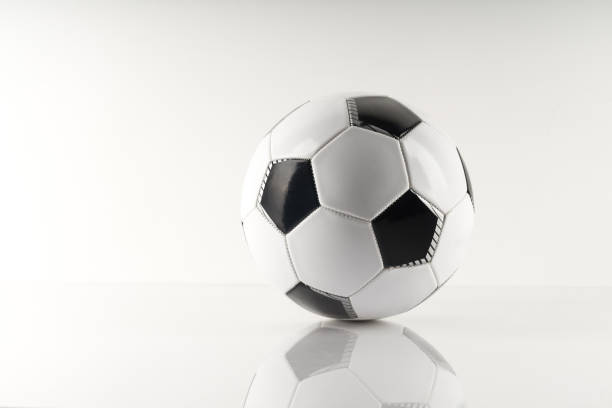 istock Classic soccer ball, typical black and white pattern, isolated on white background. 1280935735