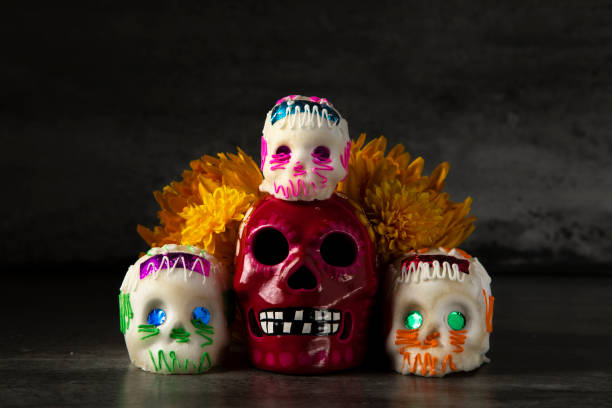 istock Day of the dead composition, sugar skulls, with black background 1280936525