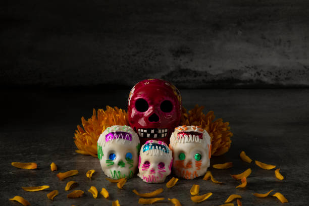 istock Day of the dead composition, sugar skulls, with black background 1280936562