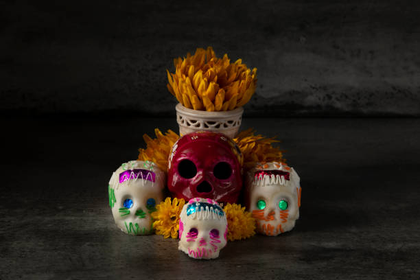 istock Day of the dead composition, sugar skulls, with black background 1280936569