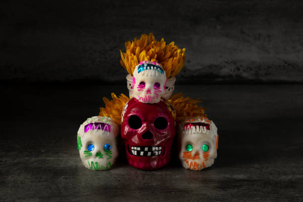 istock Day of the dead composition, sugar skulls, with black background 1280936688
