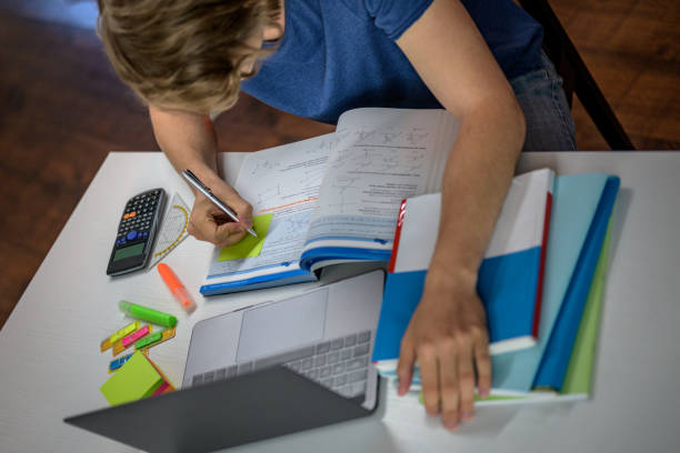istock High angle view of college student learning at home. 1280936917