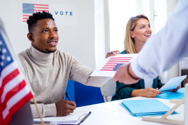 istock People voting in polling place, usa elections and coronavirus. 1280937580